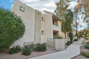 A building with the number 4 on it is surrounded by a garden. at The Viridian Apartments, Arizona, 85250